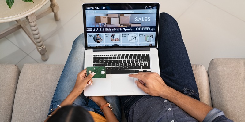 Couple completing an online purchase on laptop