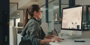 woman sitting at desk working on website design